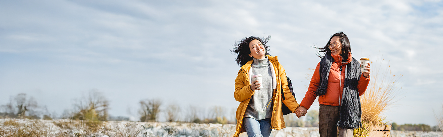 two women in coats walking outside
