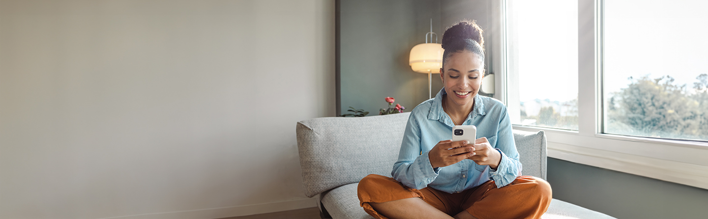 women smiling and using a phone
