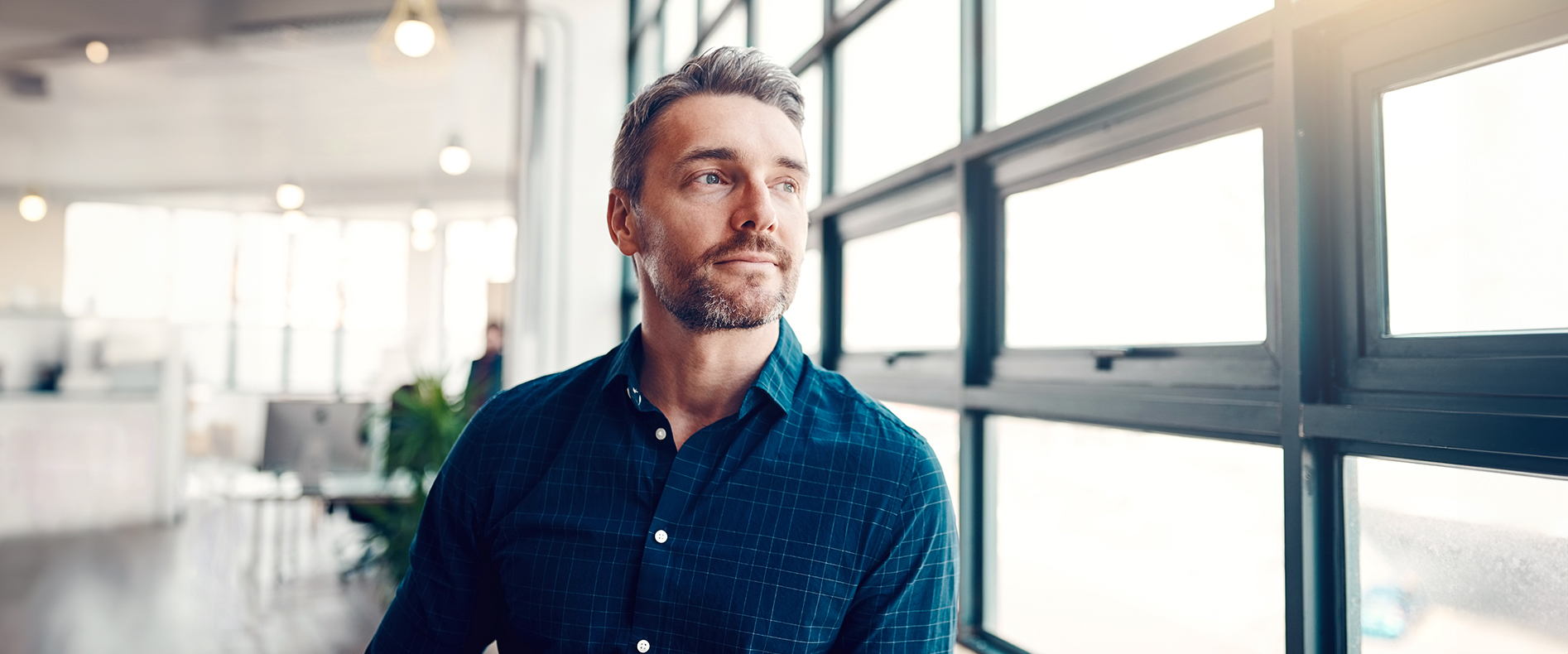 Man looking out window